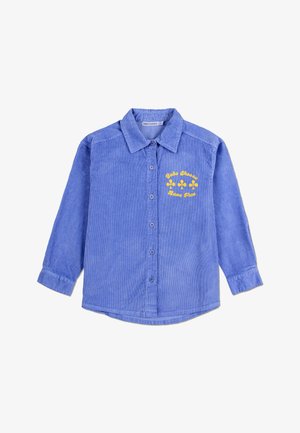 Modrá kordurová košile s designem na knoflíky, dlouhými rukávy a žlutou květinovou grafikou s nápisem "Bav se." Výrazná struktura s ribbováním.