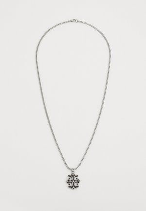 Silver necklace with a chain design and an ornate pendant featuring a symmetrical, floral-like pattern at its center.