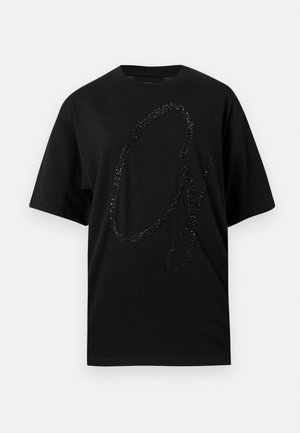 Schwarzes T-Shirt aus Baumwolle mit einem großen, funkelnden schwarzen Glitzergrafik in Form eines stilisierten "G". Kurzärmlig, lockere Passform.