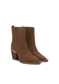 Botas de ante marrón hasta el tobillo con costuras verticales, punteras en punta y tacones de bloque que presentan un acento metálico en la base del tacón.