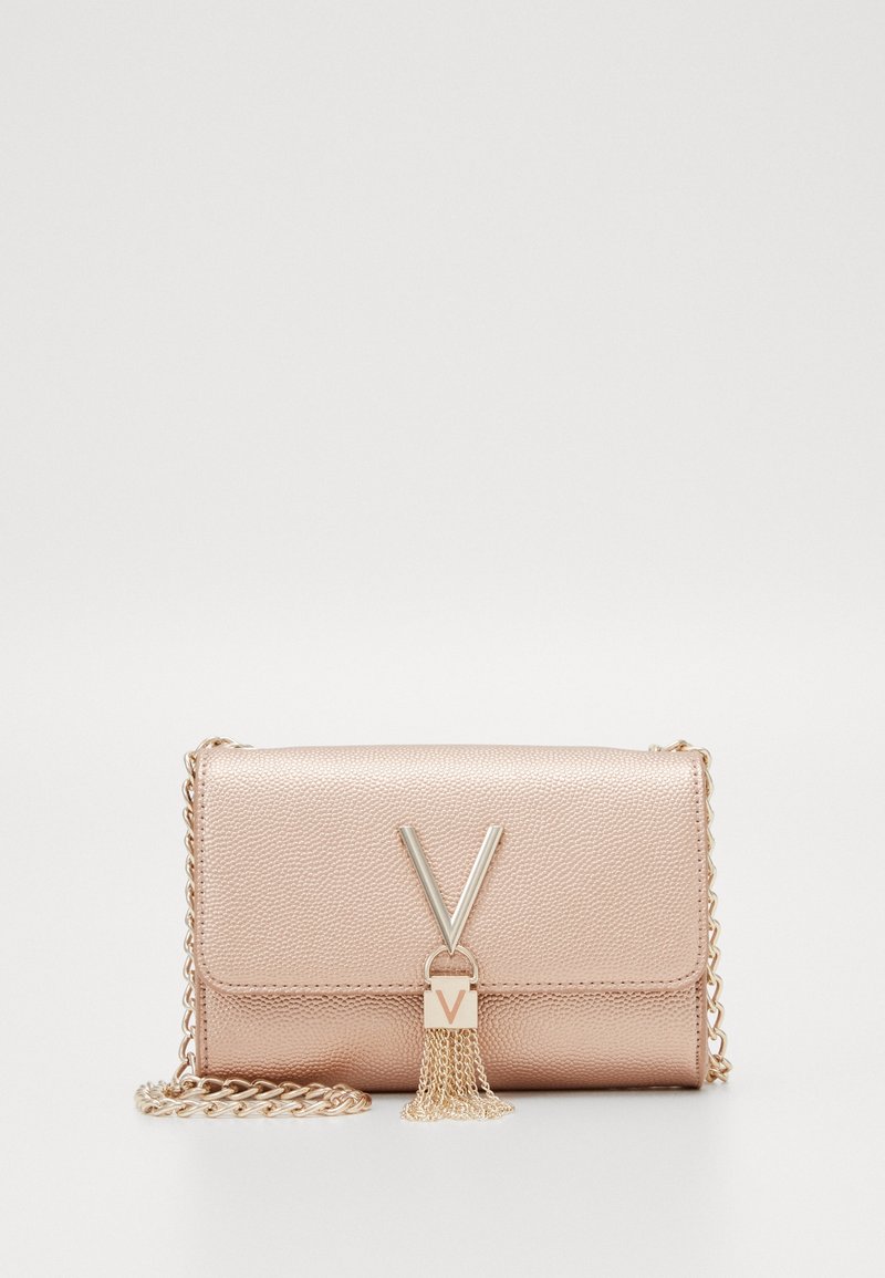 Metalická růžová kabelka typu clutch s texturovaným syntetickým materiálem, ozdobená řetízkem, zlatými prvky a detailem s třásněmi, který má tvar písmene V.
