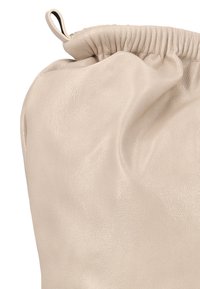 Béžová kožená taška s měkkým, texturovaným povrchem, vybavená nařaseným horním okrajem a vnitřním zavazováním na tkaničku.