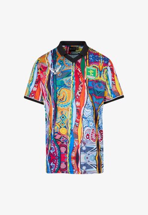 Multicolored short-sleeve football jersey with black collar, abstract vertical patterns, white logo on left chest, and green club badge on right chest.