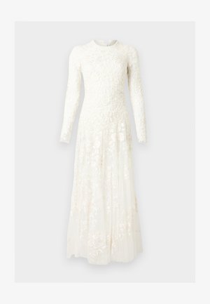 Long white lace dress with floral patterns, long sleeves, fitted bodice, and flowing pleated skirt on a plain background.