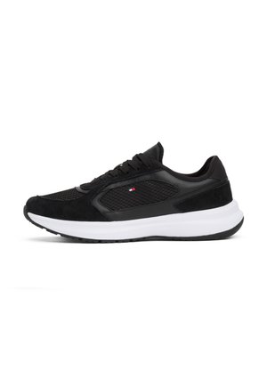 Black athletic sneaker with mesh and suede upper, white thick sole, and small red, white, and blue logo on side panel.