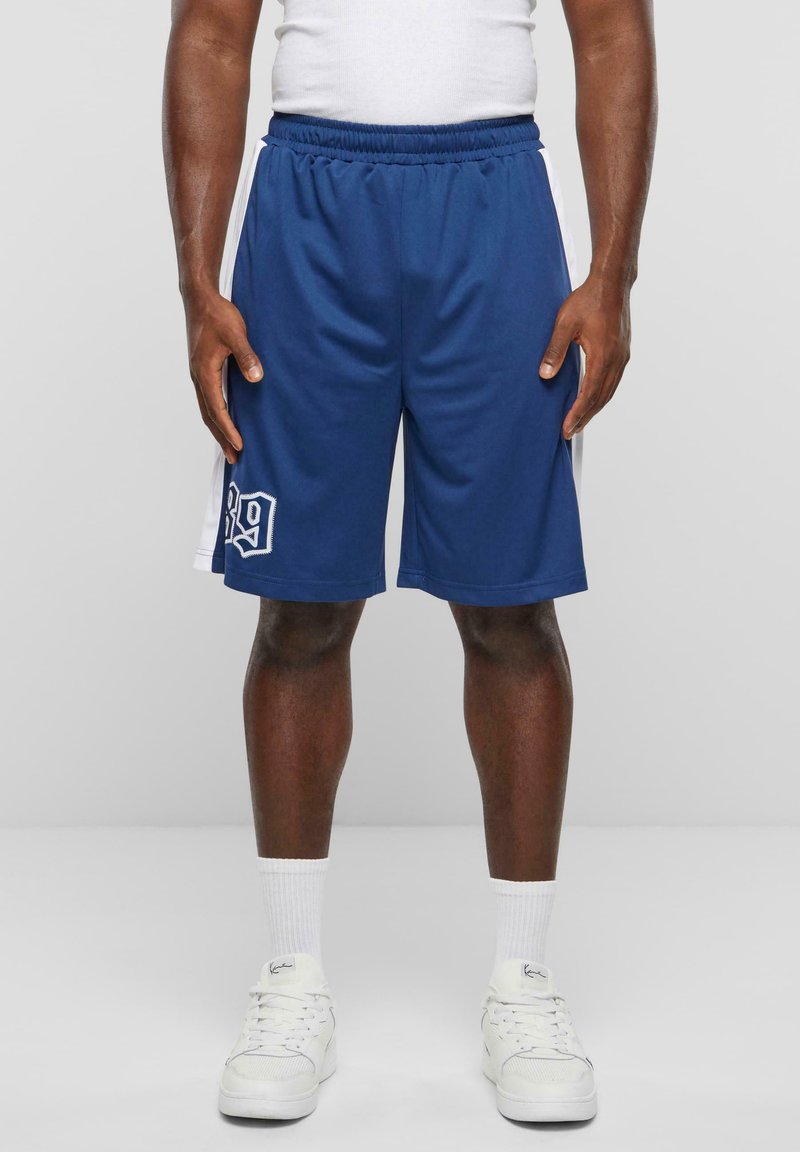 Marineblå sportsshorts med en hvid sidestribe og dekorativ syning. Har et broderet nummer 89 på det nederste venstre ben.
