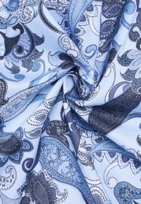Tessuto azzurro chiaro con un intricato motivo paisley in blu navy e blu scuro, caratterizzato da swirl e forme dettagliate, texture liscia.