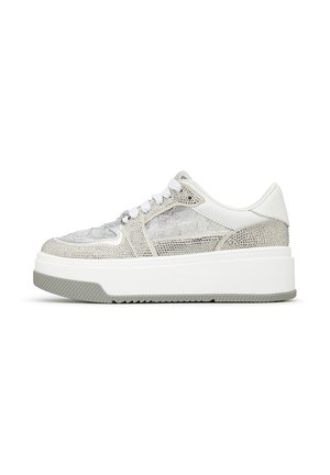White platform sneaker with silver rhinestones and lace floral detailing, white laces, and a thick textured grey sole.
