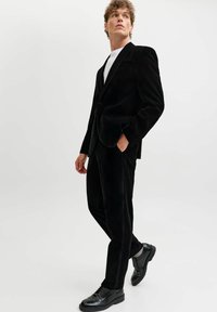 Čierny kordúrový blejc a nohavice so štíhlym dizajnom. Blejc má jeden gombík a klopové reverzné límce, doplnené lesklými čiernymi dress shoes.