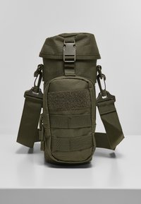 Zielona taktyczna torba wykonana z wytrzymałego materiału. Posiada regulowany pasek, kieszeń na zamek oraz taśmy do mocowania. Kompaktowy design.