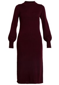 Burgundin pusero mekko korkean kaula-aukon ja pitkien puffihihnojen kanssa, jossa on vartalonmyötäinen siluetti ja medium-pitkä helma. Pehmeä tekstuuri.