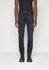 Svarta denimjeans med slim fit, med klassisk femfickdesign, en slät yta och en standard midjeresor med framknapplås.