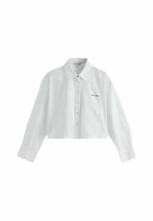 Chemise courte blanche à manches longues avec boutons, col pointu et petit texte rouge brodé sur la poche poitrine gauche.