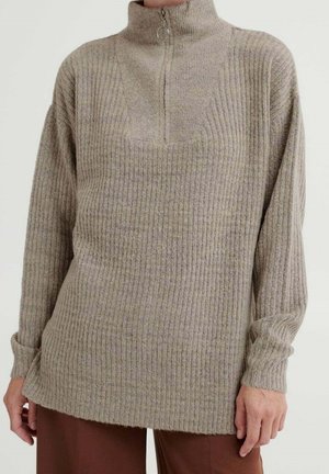 Pull léger beige en tricot texturé avec un col zippé mi-hauteur, motif côtelé et manches longues. Présente une coupe décontractée et un ourlet légèrement allongé.