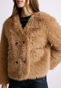 Braune Kunstpelzjacke mit einer strukturierten, flauschigen Außenseite. Verfügt über ein doppelt geknöpftes Design und versteckte Taschen für zusätzliche Funktionalität.