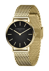 Goldenes Uhrenarmband aus Mesh mit rundem schwarzem Zifferblatt, versehen mit goldenen Stundenmarkierungen und Zeigern. Der Markenname "LIEBESKIND" ist auf dem Zifferblatt zu sehen.