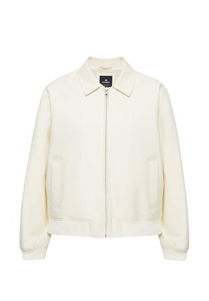 Krémfehér cipzáras dzseki gallérral, hosszú ujjal, két első zsebbel, valamint rugalmas alsó szegéllyel és mandzsettával.