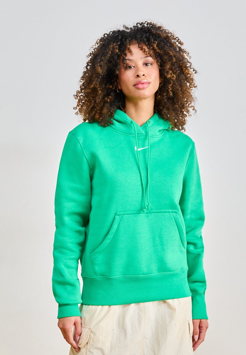 Green hoodie made of soft material with a front pocket, drawstring hood, and ribbed cuffs. Features a small white logo on the chest.