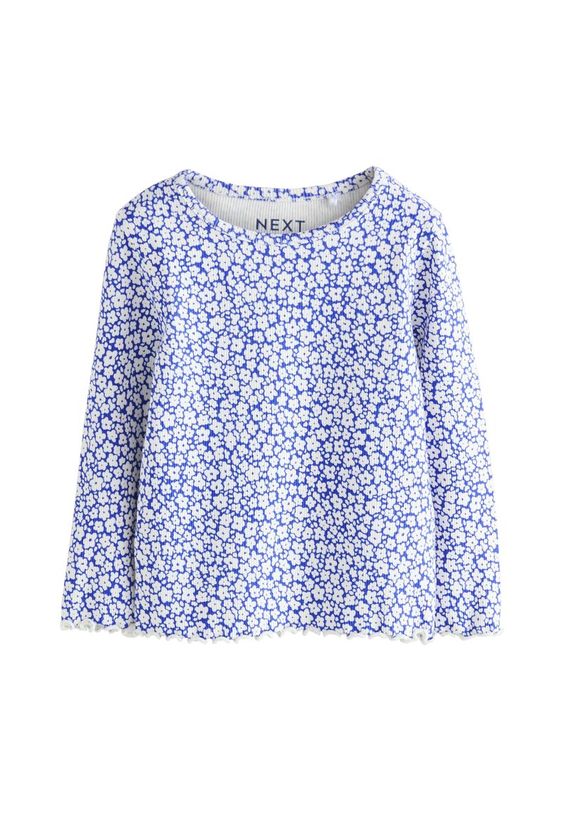 Hosszú ujjú kék virágmintás felső, fehér virágmintával, bordázott nyakkivágással és hullámos szegéllyel. Puha, könnyű anyagból készült.