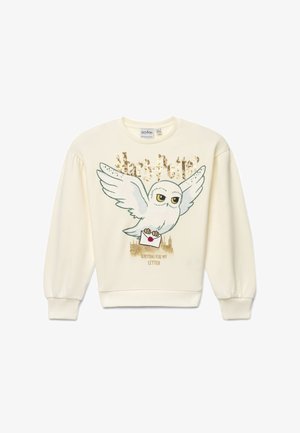 Sweat-shirt crème avec une chouette blanche tenant une lettre scellée, texte doré "Harry Potter" et "Waiting for my letter" en dessous.