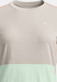 Short-sleeve t-shirt in light gray with a mint green lower section and coral accent stitching. Soft fabric with a round neck design.