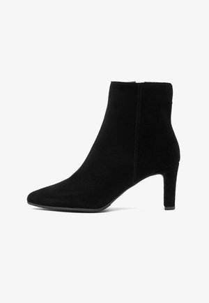 Zwarte suède enkellaarsjes met een spitse neus, slanke hak en naadloos ontwerp, met een matte textuur en zonder zichtbare hardware.