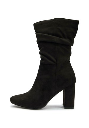 Black suede ankle boot with a slouchy design, pointed toe, and thick block heel for stability. Smooth texture with no visible hardware.
