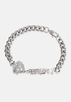 Hõbedane kettbracelet suure linkidega, millel on dekoratiivne südamevärv ja graveeritud silt sõnaga "Igavik". Sile tekstuur.