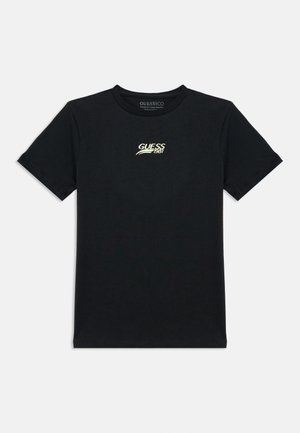 Czarny bawełniany T-shirt z małym żółto-białym logo "GUESS 1981" na lewej piersi. Okrągły dekolt, krótkie rękawy.