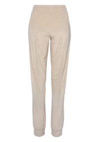 Beige, joggers met elastische tailleband, van gestructureerde stof, met taps toelopende benen en manchet bij de enkels. Minimalistisch ontwerp zonder zichtbare patronen of accenten.