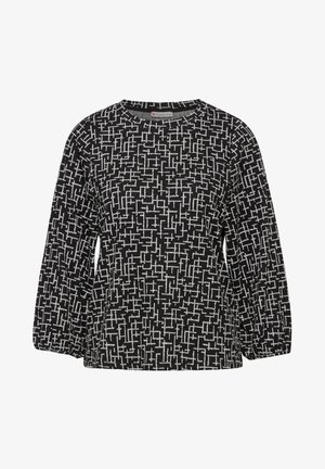 Haut noir à manches longues avec un motif géométrique blanc. Tissu doux, col rond et coupe légèrement ample avec des poignets froncés.