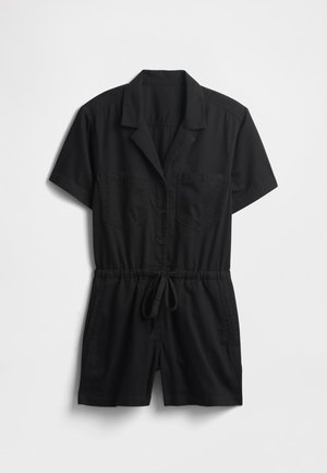 Must lühikeste varrukatega kombinesoon, valmistatud kergest kangast, mis on varustatud kraega, ees olevate nööpidega, kahe rinnatasku ja reguleeritava nöörvööga.