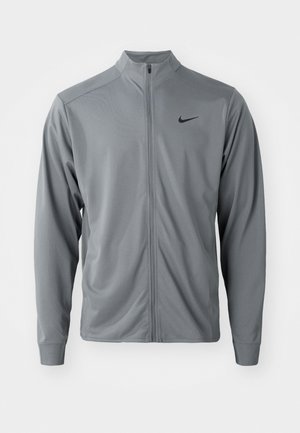 Grå lynlåsjakke med høj krave, lavet af glat, letvægtsstof. Har sort Nike-logo på venstre bryst og lange ærmer.