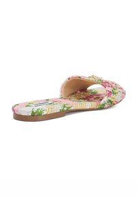 Floral slip-on sandal featuring a pink fabric upper with green, yellow, and white accents. Flat sole with a simple buckle detail.