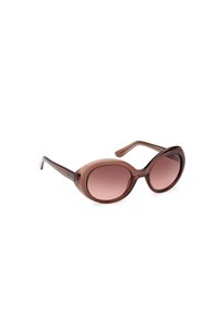 Lunettes de soleil ovales surdimensionnées marron avec des verres teintés dégradés et des branches fines sur fond blanc.
