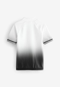 Kortärmad sporttröja med en gradient från vitt till svart och ett prickigt mönster. Tyget har en mjuk textur, med svarta detaljer på ärmarna.