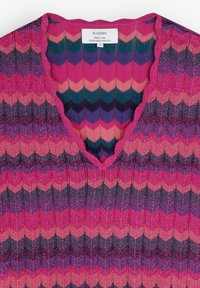 V-neck knitted top in multicolored zigzag pattern featuring pink, purple, and teal hues; textured fabric with a slight shimmer.