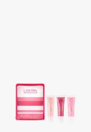 Trousse cosmétique Lancôme Beach Club rayée rose et blanche avec trois gloss Juicy Tubes en rose clair, rouge et rose moyen.
