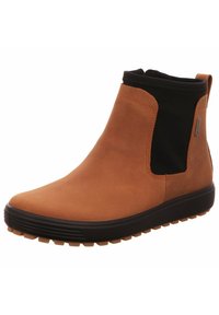 Stivaletto in pelle marrone con pannelli elastici ai lati e una parte superiore nera. Presenta una suola in gomma texture per aderenza e durata.