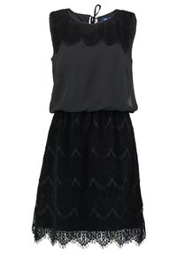 Robe noire sans manches avec un haut transparent et un bas en dentelle texturée présentant des bords festonnés et un motif ondulé. Lien ajustable à l'arrière.