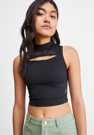 Haut de sport noir à col montant, avec des détails découpés, des lignes de couture et un accent logo sur le côté gauche. Tissu lisse et extensible.