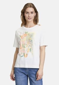 T-shirt en coton blanc à manches courtes avec un imprimé graphique représentant des fruits et le texte "LA DOLCE VITA" en nuances de rose et de vert.