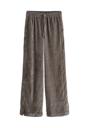 Pantalon en velours côtelé marron coupe ample avec taille élastique et cordon, avec petites fentes latérales à l'ourlet.
