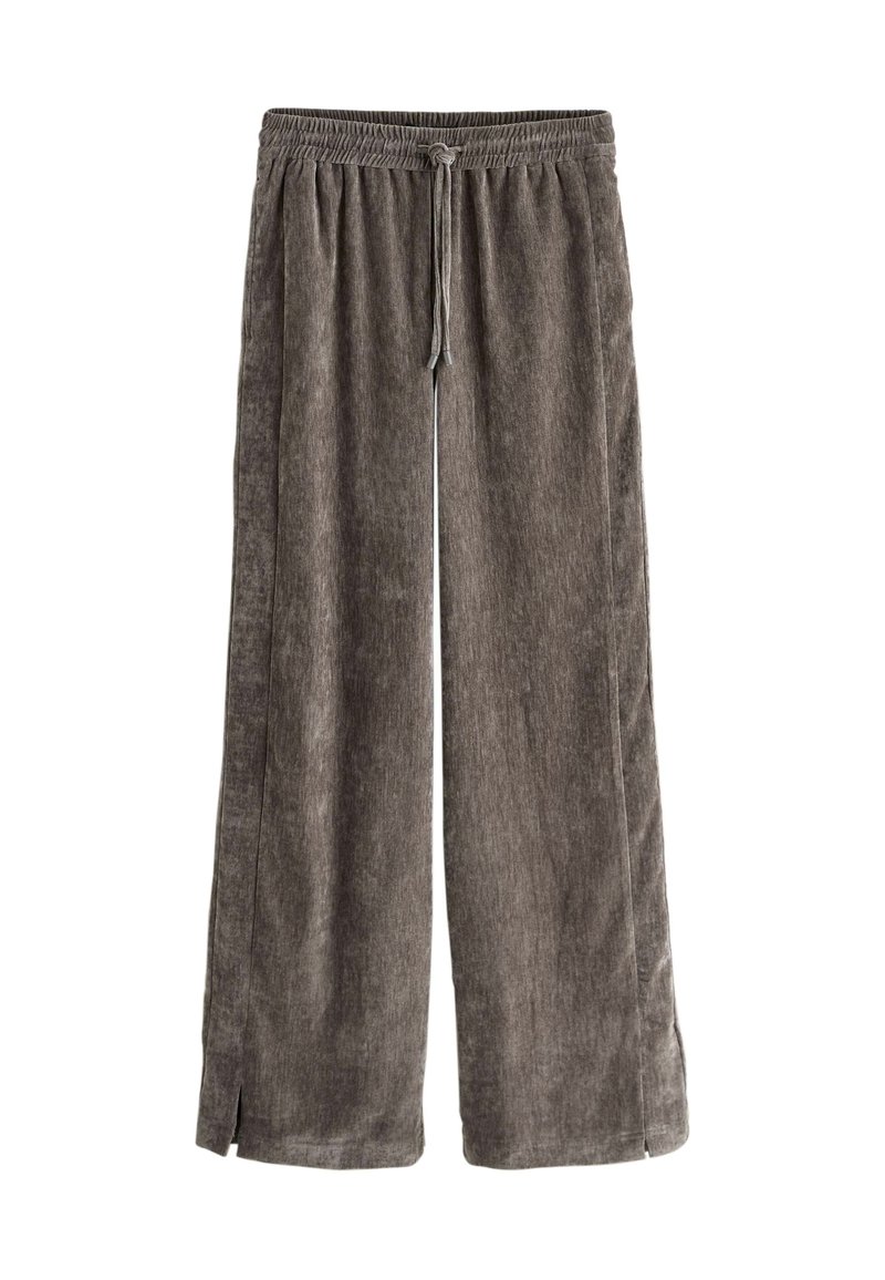 Pantalon en velours côtelé marron coupe ample avec taille élastique et cordon, avec petites fentes latérales à l'ourlet.
