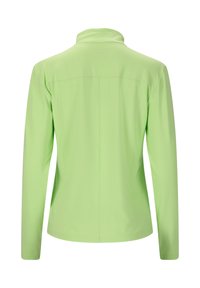 Veste longue à manches longues vert clair avec un col montant vue de dos sur un fond blanc.