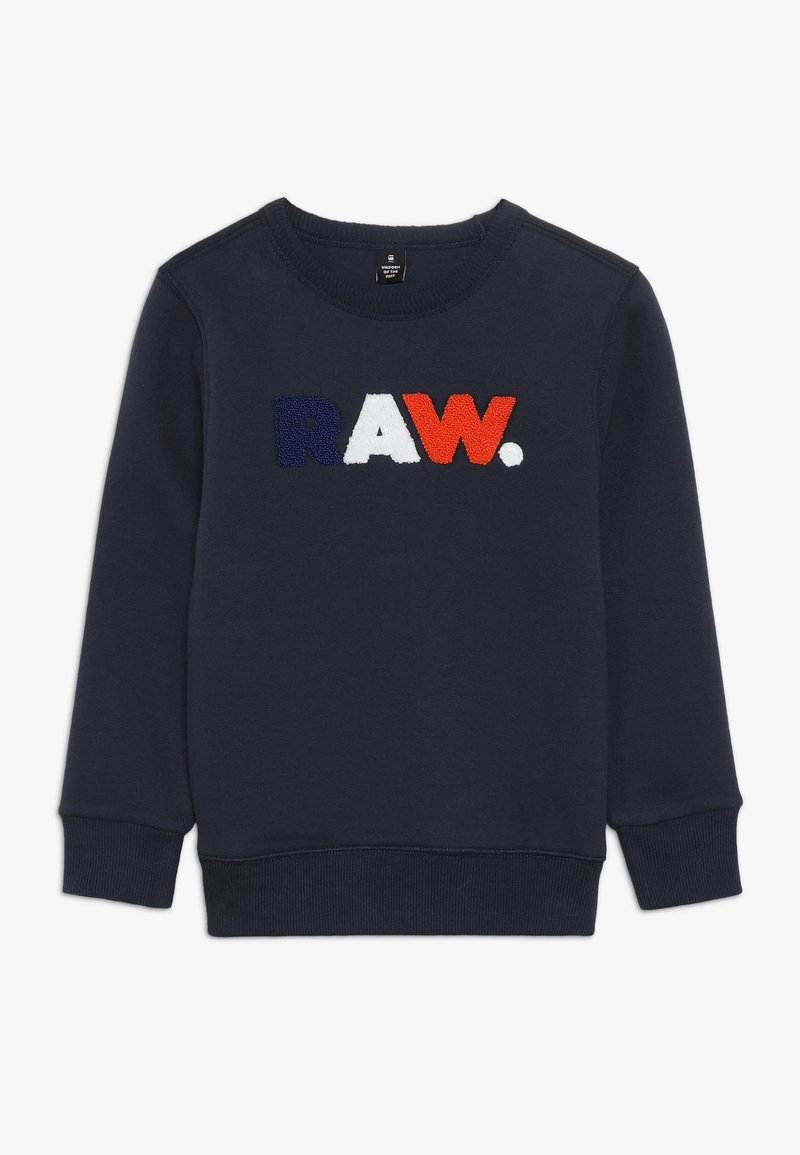 Sweatshirt de marine avec le texte "RAW." à l'avant en broderie fuzzy bleue, blanche et orange. Poignets et ourlet côtelés, texture lisse.