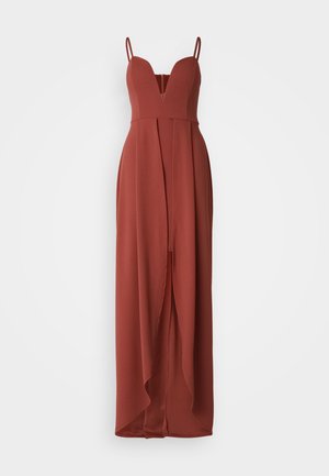 Vestido largo sin mangas de color óxido con un escote en V profundo, corsé ajustado y una falda fluida que presenta una abertura frontal. Tejido suave.