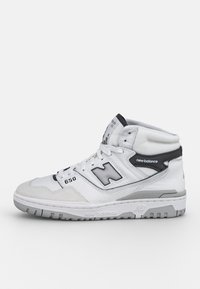 High-top sneaker with a white leather upper, grey accents, perforated textures, and a grey rubber sole. Features a prominent "N" logo.