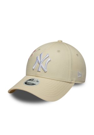 Beige baseball cap with white embroidered New York Yankees logo and a curved brim, shown at a slight angle on a white background.