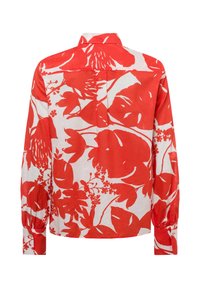 Camicia a maniche lunghe rossa a fiori, materiale in cotone, sfondo bianco, con foglie e fiori tropicali oversize, polsini con bottoni e colletto.